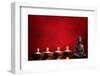 Buddha and Candles on Red Background, Religious Concept.-Sofiaworld-Framed Photographic Print