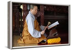 Buddhist ceremony at temple, monk playing on a wooden fish (percussion instrument)-Godong-Framed Photographic Print