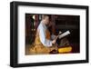 Buddhist ceremony at temple, monk playing on a wooden fish (percussion instrument)-Godong-Framed Photographic Print