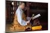 Buddhist ceremony at temple, monk playing on a wooden fish (percussion instrument)-Godong-Mounted Photographic Print