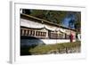 Buddhist Monk in Red Robes Turning Prayer Wheels in Contemplative Morning Prayer-Annie Owen-Framed Photographic Print