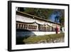 Buddhist Monk in Red Robes Turning Prayer Wheels in Contemplative Morning Prayer-Annie Owen-Framed Photographic Print