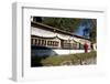 Buddhist Monk in Red Robes Turning Prayer Wheels in Contemplative Morning Prayer-Annie Owen-Framed Photographic Print