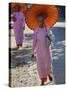 Buddhist Nuns with Bamboo-Framed Orange Umbrellas Walk Through Streets of Sittwe, Burma, Myanmar-Nigel Pavitt-Stretched Canvas