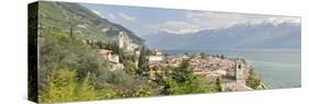 Buildings at the Waterfront with Snowcapped Mountain in the Background, Gargnano, Monte Baldo-null-Stretched Canvas