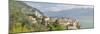 Buildings at the Waterfront with Snowcapped Mountain in the Background, Gargnano, Monte Baldo-null-Mounted Photographic Print