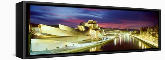 Buildings Lit Up at Dusk, Guggenheim Museum Bilbao, Bilbao, Vizcaya, Spain-null-Framed Stretched Canvas