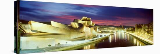 Buildings Lit Up at Dusk, Guggenheim Museum Bilbao, Bilbao, Vizcaya, Spain-null-Stretched Canvas