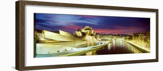 Buildings Lit Up at Dusk, Guggenheim Museum Bilbao, Bilbao, Vizcaya, Spain-null-Framed Photographic Print
