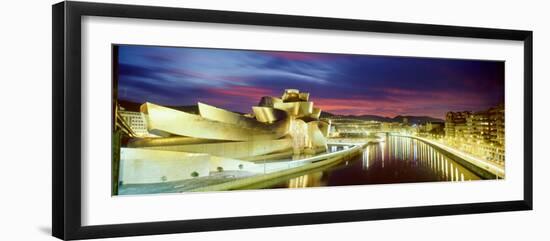 Buildings Lit Up at Dusk, Guggenheim Museum Bilbao, Bilbao, Vizcaya, Spain-null-Framed Photographic Print