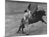 Bull Fighter Manolete Raising His Cape as Bull Charges Past Him in Bull Ring During Bull Fight-William C^ Shrout-Mounted Premium Photographic Print