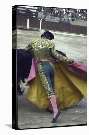 Bullfighter Manuel Benitez, Known as "El Cordobes," Sweeping His Cape Aside a Charging Bull-Loomis Dean-Stretched Canvas