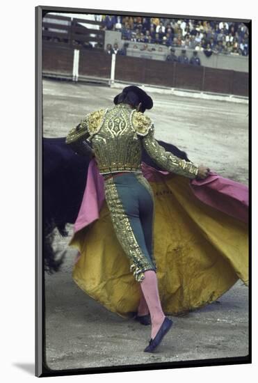 Bullfighter Manuel Benitez, Known as "El Cordobes," Sweeping His Cape Aside a Charging Bull-Loomis Dean-Mounted Photographic Print