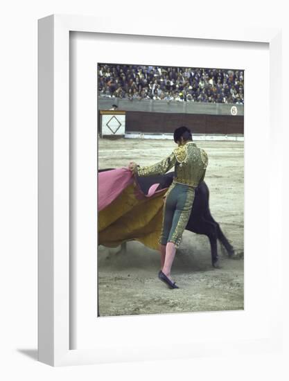 Bullfighter Manuel Benitez, Known as "El Cordobes," Sweeping His Cape Aside the Charging Bull-Loomis Dean-Framed Photographic Print