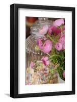 bunch of buttercups and candy necklaces in storage jar, Ranunculus asiaticus, close-up-Sandra Gutekunst-Framed Photographic Print