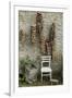 Bunches of Onions Drying Out on Brick Wall with Chair-Christina Wilson-Framed Photo