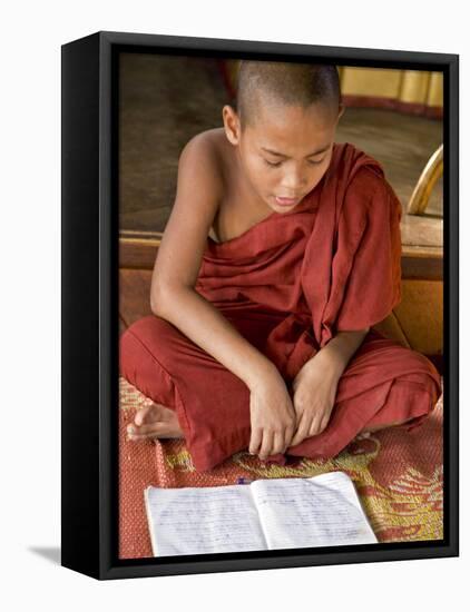 Burma, Lake Inle, A Young Novice Monk Learning at a Monastery School on Lake Inle, Myanmar-Nigel Pavitt-Framed Stretched Canvas