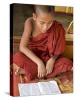 Burma, Lake Inle, A Young Novice Monk Learning at a Monastery School on Lake Inle, Myanmar-Nigel Pavitt-Stretched Canvas