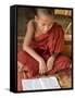 Burma, Lake Inle, A Young Novice Monk Learning at a Monastery School on Lake Inle, Myanmar-Nigel Pavitt-Framed Stretched Canvas