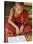 Burma, Lake Inle, A Young Novice Monk Learning at a Monastery School on Lake Inle, Myanmar-Nigel Pavitt-Stretched Canvas