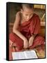 Burma, Lake Inle, A Young Novice Monk Learning at a Monastery School on Lake Inle, Myanmar-Nigel Pavitt-Framed Stretched Canvas