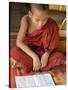 Burma, Lake Inle, A Young Novice Monk Learning at a Monastery School on Lake Inle, Myanmar-Nigel Pavitt-Stretched Canvas