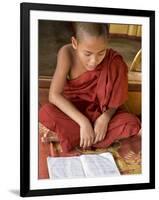 Burma, Lake Inle, A Young Novice Monk Learning at a Monastery School on Lake Inle, Myanmar-Nigel Pavitt-Framed Premium Photographic Print