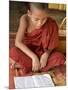 Burma, Lake Inle, A Young Novice Monk Learning at a Monastery School on Lake Inle, Myanmar-Nigel Pavitt-Mounted Premium Photographic Print