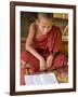 Burma, Lake Inle, A Young Novice Monk Learning at a Monastery School on Lake Inle, Myanmar-Nigel Pavitt-Framed Photographic Print