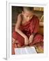 Burma, Lake Inle, A Young Novice Monk Learning at a Monastery School on Lake Inle, Myanmar-Nigel Pavitt-Framed Photographic Print