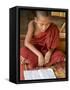 Burma, Lake Inle, A Young Novice Monk Learning at a Monastery School on Lake Inle, Myanmar-Nigel Pavitt-Framed Stretched Canvas