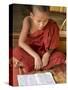 Burma, Lake Inle, A Young Novice Monk Learning at a Monastery School on Lake Inle, Myanmar-Nigel Pavitt-Stretched Canvas