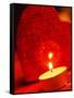 Burning tea warmer candle in front of a heart-null-Framed Stretched Canvas