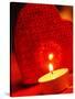 Burning tea warmer candle in front of a heart-null-Stretched Canvas