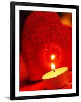 Burning tea warmer candle in front of a heart-null-Framed Photographic Print