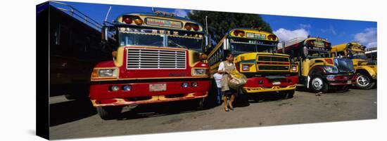 Buses Parked in a Row at a Bus Station, Antigua, Guatemala-null-Stretched Canvas