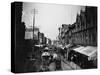 Bustling View of Fulton St, with Rows of Shops and Horse Drawn Carriages-Wallace G^ Levison-Stretched Canvas
