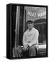 Butcher Taking a Break, Sitting in Front of Meat Market-Ed Clark-Framed Stretched Canvas