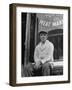 Butcher Taking a Break, Sitting in Front of Meat Market-Ed Clark-Framed Photographic Print