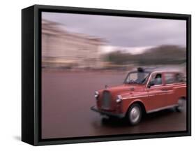 Cab racing past Buckingham Palace, London, England-Alan Klehr-Framed Stretched Canvas