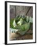 Cabbage on Chopping Board in Front of Wooden Wall-null-Framed Photographic Print