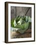 Cabbage on Chopping Board in Front of Wooden Wall-null-Framed Photographic Print