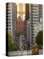 Cable Car Crossing California Street With Bay Bridge Backdrop in San Francisco, California, USA-Chuck Haney-Stretched Canvas