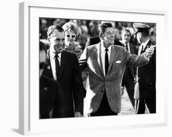 Calif Gov Ronald Reagan Escorts Pres-Elect Richard Nixon across Field at Halftime of Rose Bowl Game-null-Framed Photo