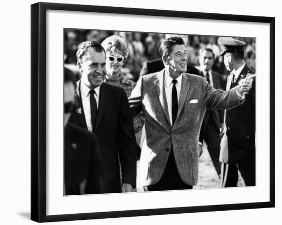 Calif Gov Ronald Reagan Escorts Pres-Elect Richard Nixon across Field at Halftime of Rose Bowl Game-null-Framed Photo