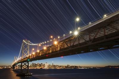 https://imgc.allpostersimages.com/img/posters/california-san-francisco-composite-of-star-trails-above-bay-bridge_u-L-Q13ASKE0.jpg?artPerspective=n