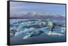 Calving icebergs in Jokulsarlon Glacier Lagoon in south Iceland-Chuck Haney-Framed Stretched Canvas