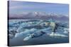 Calving icebergs in Jokulsarlon Glacier Lagoon in south Iceland-Chuck Haney-Stretched Canvas