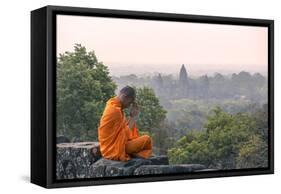 Cambodia, Siem Reap, Angkor Wat Complex. Monk Meditating with Angor Wat Temple in the Background-Matteo Colombo-Framed Stretched Canvas