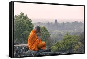 Cambodia, Siem Reap, Angkor Wat Complex. Monk Meditating with Angor Wat Temple in the Background-Matteo Colombo-Framed Stretched Canvas